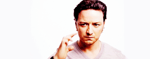James McAvoy touching his temple and squinting his face as if concentrating very hard